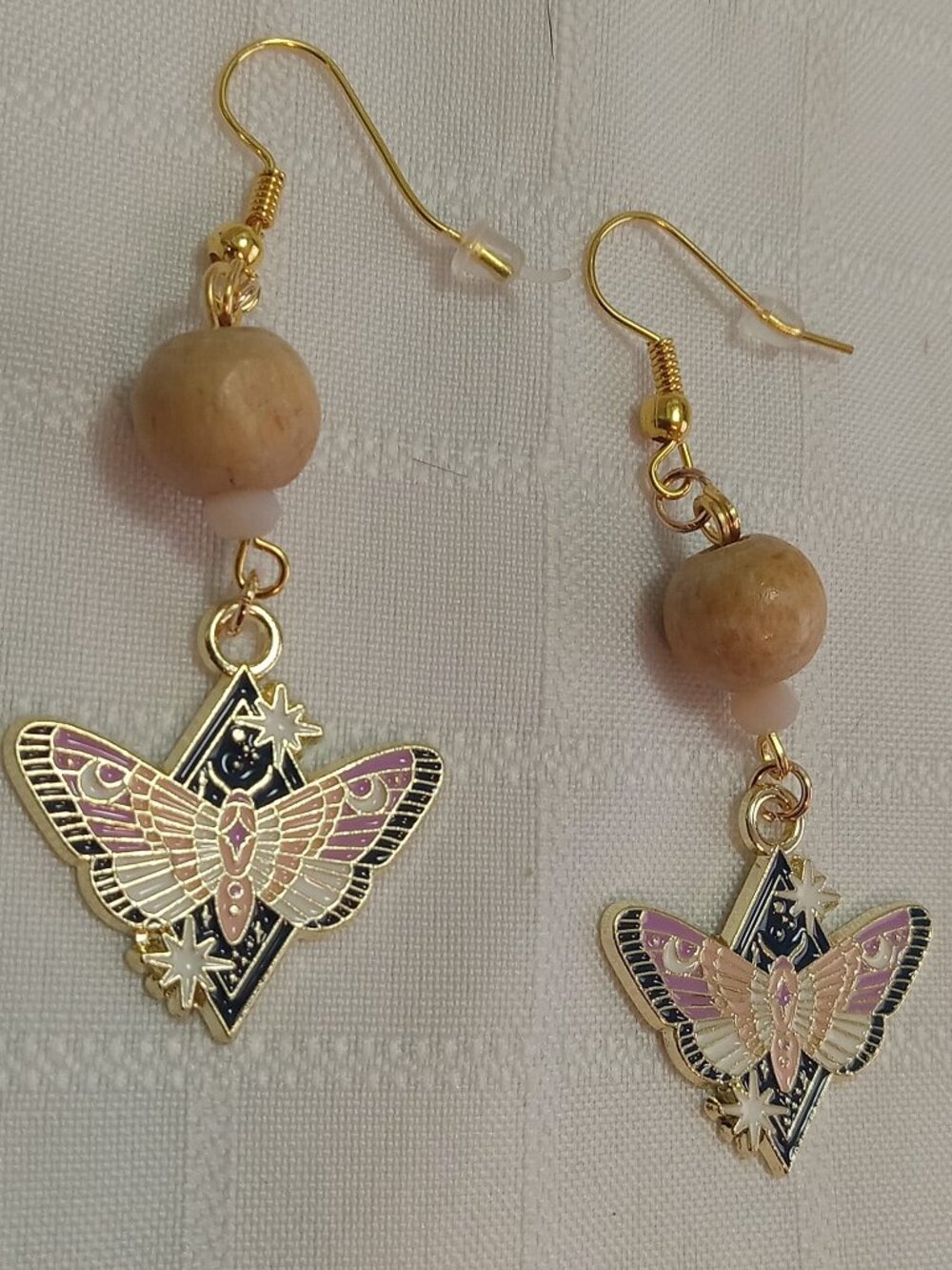 Handmade gold-colored earrings with multicolored enameled butterflies and beads